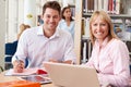 Teacher Helping Mature Student With Studies In Library Royalty Free Stock Photo