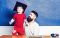 Teacher helping pupils studying on desks in classroom. Blackboard copy space. School children. Little students Royalty Free Stock Photo