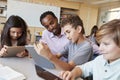 Teacher helping school kids using tablet computers in class Royalty Free Stock Photo