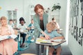 Teacher helping a schoolboy to read the task. Royalty Free Stock Photo