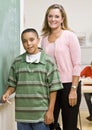 Teacher helping student at blackboard