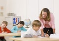 Teacher helping student in classroom Royalty Free Stock Photo