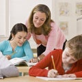 Teacher helping student in classroom