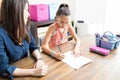 Teacher Helping Student In Schoolwork At Home