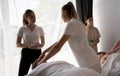 Teacher helping student training to become masseuse, women doing back massage to patient Royalty Free Stock Photo