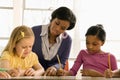 Teacher Helping Students With Schoolwork Royalty Free Stock Photo