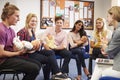 Teacher Helping Students Taking Childcare Course