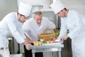 Teacher helping students training to work in catering Royalty Free Stock Photo