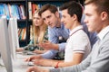 Teacher Helping Students Working At Computers Royalty Free Stock Photo