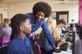 Teacher Helping Teenage Male High School Student Working In Computer Class Royalty Free Stock Photo