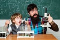 Teacher helping young boy with lesson. Homeschooling. Teacher helping pupils studying at desks in classroom. Ready for Royalty Free Stock Photo