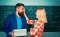 Teacher helping young student with lesson. Nerd funny student preparing for university exams. Concept of education and Royalty Free Stock Photo