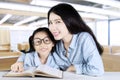 Teacher helps her student to study in class Royalty Free Stock Photo