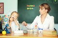 Teacher and her students in classroom. Teacher helping schoolgirl with her homework in classroom at school Royalty Free Stock Photo