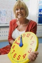 Teacher Holding A Time Teaching Clock