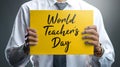 Teacher Holding World Teacher`s Day Yellow Poster