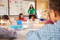 Teacher instructing elementary school kids in classroom Royalty Free Stock Photo