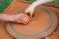 Teacher and kid making ceramic pot. Potters and child hands. Pottery workshop outside Royalty Free Stock Photo