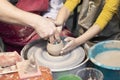 Teacher and kid making ceramic pot on pottery wheel Royalty Free Stock Photo