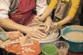 Teacher and kid making ceramic pot on pottery wheel Royalty Free Stock Photo