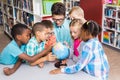 Teacher and kids discussing globe Royalty Free Stock Photo