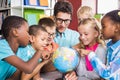 Teacher and kids discussing globe Royalty Free Stock Photo