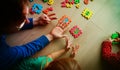 Teacher and kids play with number puzzle