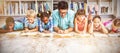 Teacher and kids reading book in library Royalty Free Stock Photo