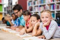 Teacher and kids reading book in library Royalty Free Stock Photo