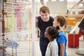 Teacher and kids talking about a science exhibit