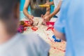 a teacher and kids trying to make forms with kinetic sand, kindergarten closeup view Royalty Free Stock Photo