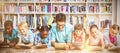 Teacher and kids using digital tablet in library Royalty Free Stock Photo