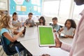 Teacher and kids using tablets in elementary school lesson