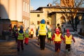 Teacher of a kindergarten with group of children on a walk