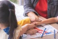 Teacher kindergarten students hand together for teamwork