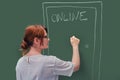 A teacher knocks on the door with online education written on the blackboard. Problems of online learning in quarantine due to the