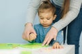 Teacher learn letters with little girl in kindergarden. Nursery