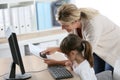 Teacher with little girl using computer Royalty Free Stock Photo