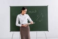 Teacher looking at book near mathematic Royalty Free Stock Photo