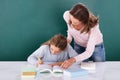 Teacher Looking At Student Doing Class Work Royalty Free Stock Photo