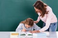 Teacher Looking At Student Doing Class Work Royalty Free Stock Photo