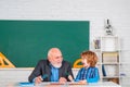 Teacher with male elementary school pupil with problem. Science education concept. Royalty Free Stock Photo