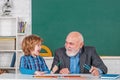 Teacher with male elementary school pupil with problem. Science education concept. Royalty Free Stock Photo