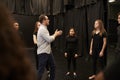 Teacher With Male And Female Drama Students At Performing Arts School In Studio Improvisation Class