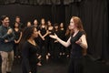 Teacher With Male And Female Drama Students At Performing Arts School In Studio Improvisation Class Royalty Free Stock Photo