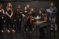 Teacher With Male And Female Drama Students At Performing Arts School In Studio Improvisation Class