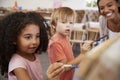 Teacher At Montessori School Helping Children in Art Class