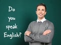 Teacher near chalkboard with question DO YOU SPEAK ENGLISH Royalty Free Stock Photo