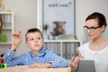 Teacher with notebook observes boy Royalty Free Stock Photo