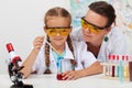 Teacher overseeing chemical experiment in science class Royalty Free Stock Photo